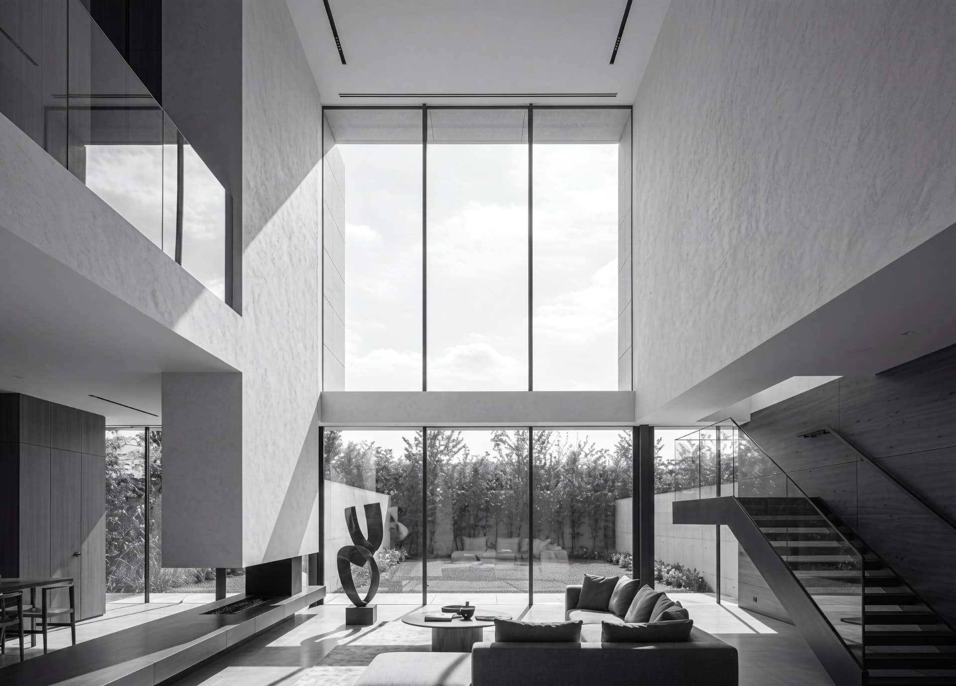 Double-height living space with full-height glazing in a private residence